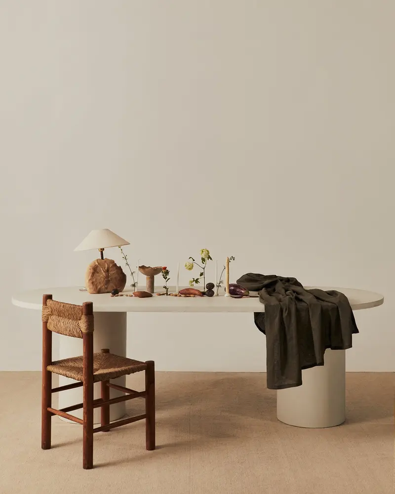 Oval Reye dining table in microcement with white beech legs