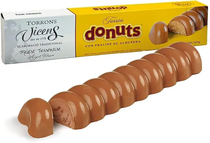 Turrón de Donuts Torrons Vicens, 300 grs. Innovador turrón con praliné de almendras y el auténtico sabor de los Donuts, elaborado por el maestro turronero Ángel Velasco.